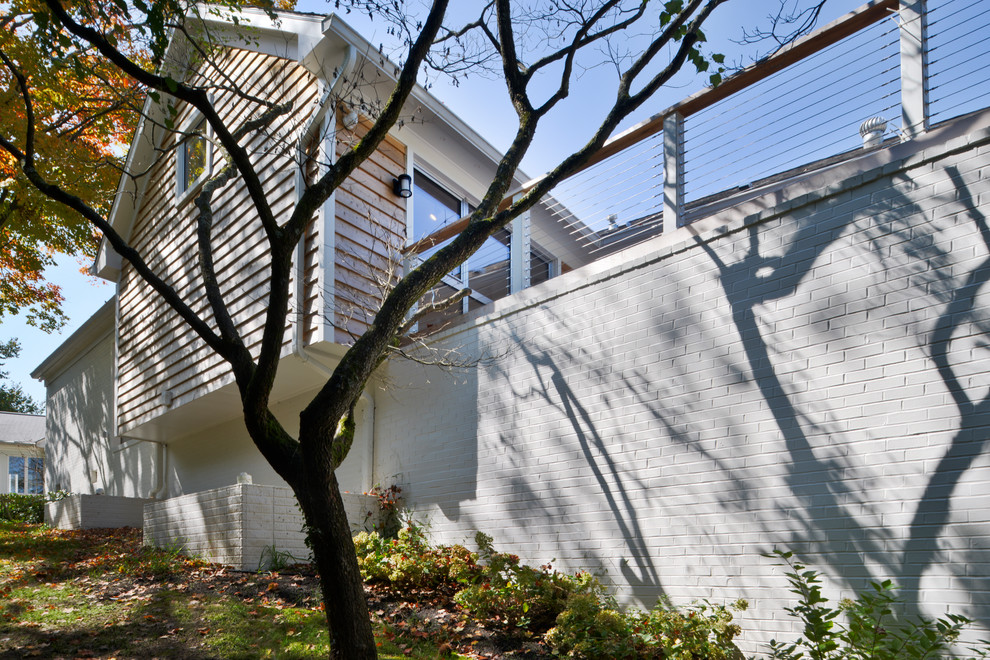 This is an example of an expansive and white modern two floor detached house in DC Metro with mixed cladding.