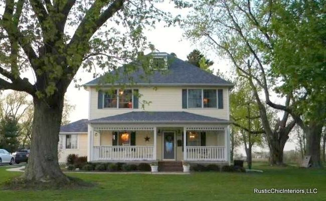 Geräumiges, Zweistöckiges Landhausstil Haus mit Vinylfassade, gelber Fassadenfarbe und Walmdach in Chicago
