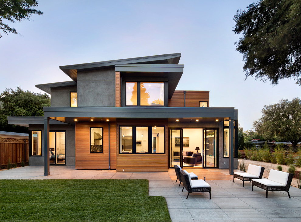 Idée de décoration pour une façade de maison grise design à un étage avec un toit en appentis et un revêtement mixte.