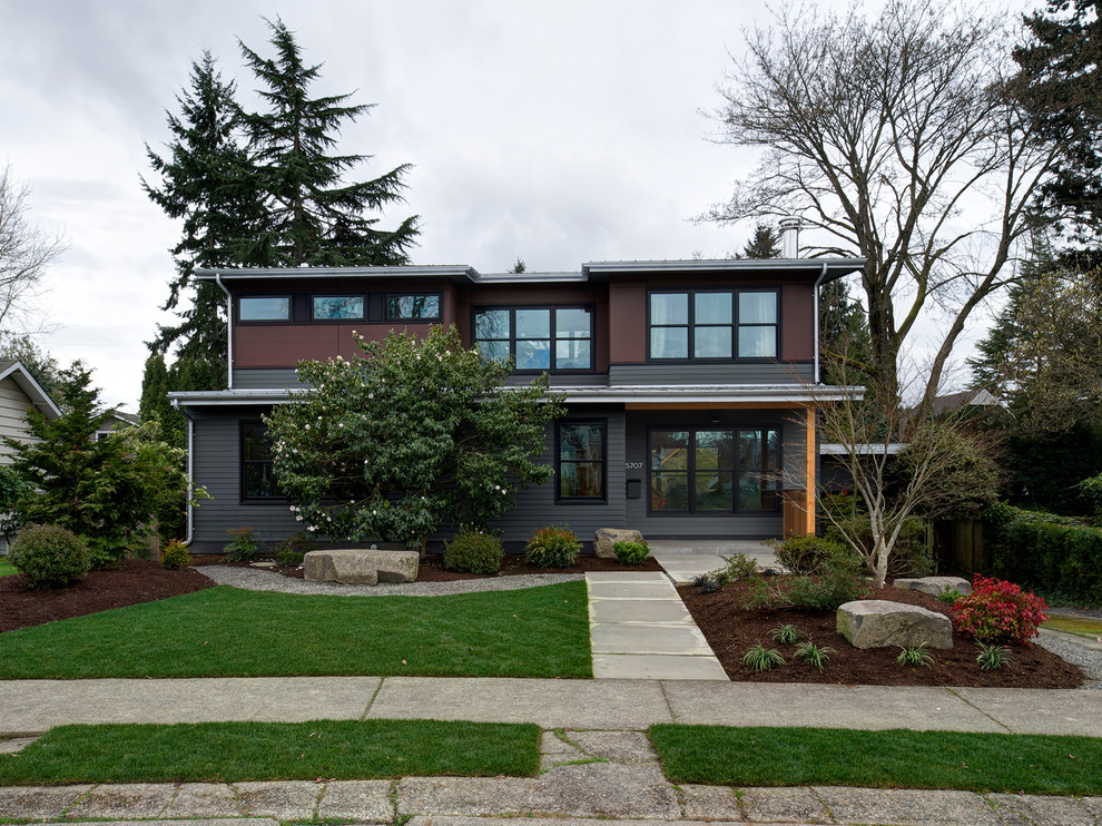 This is an example of a medium sized contemporary two floor house exterior in Seattle with concrete fibreboard cladding.