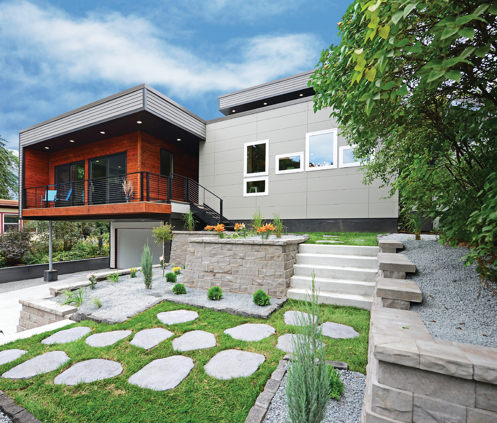 Modelo de fachada de casa multicolor contemporánea con revestimientos combinados y tejado plano