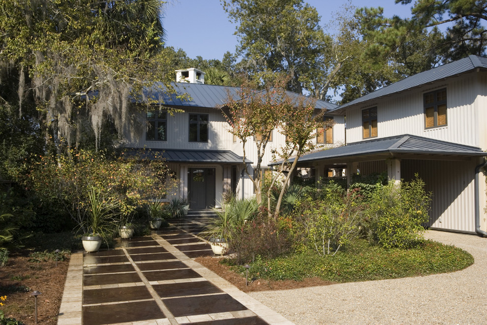 Example of a mid-sized trendy gray two-story wood exterior home design in Charleston with a hip roof