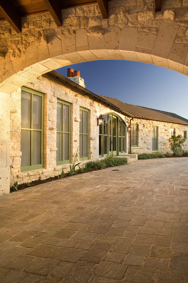 This is an example of a rustic house exterior in Austin with stone cladding.