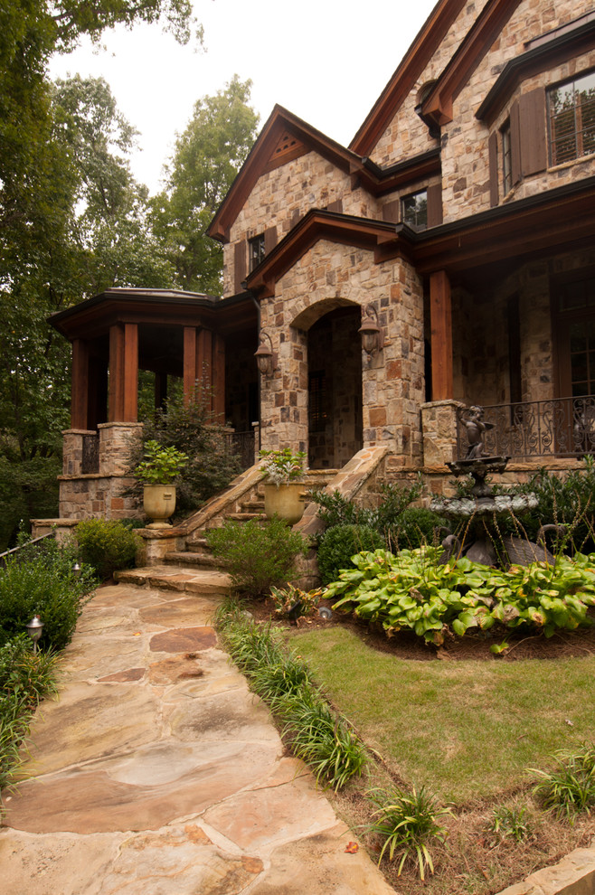 Inspiration for a mediterranean beige two-story stone exterior home remodel in Atlanta