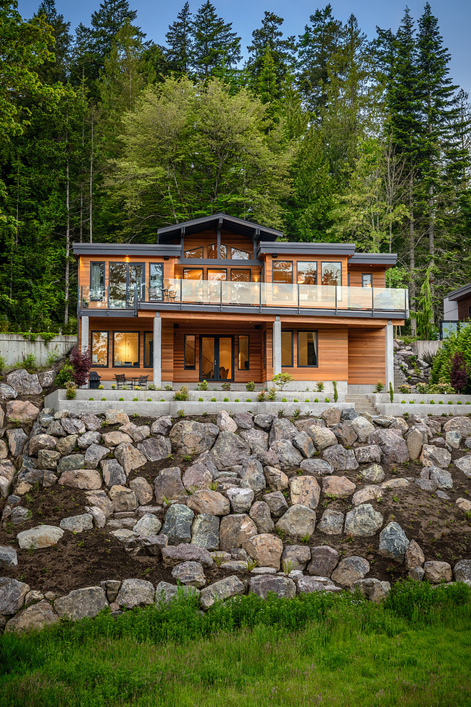 Inspiration for a contemporary house exterior in Vancouver with wood cladding.