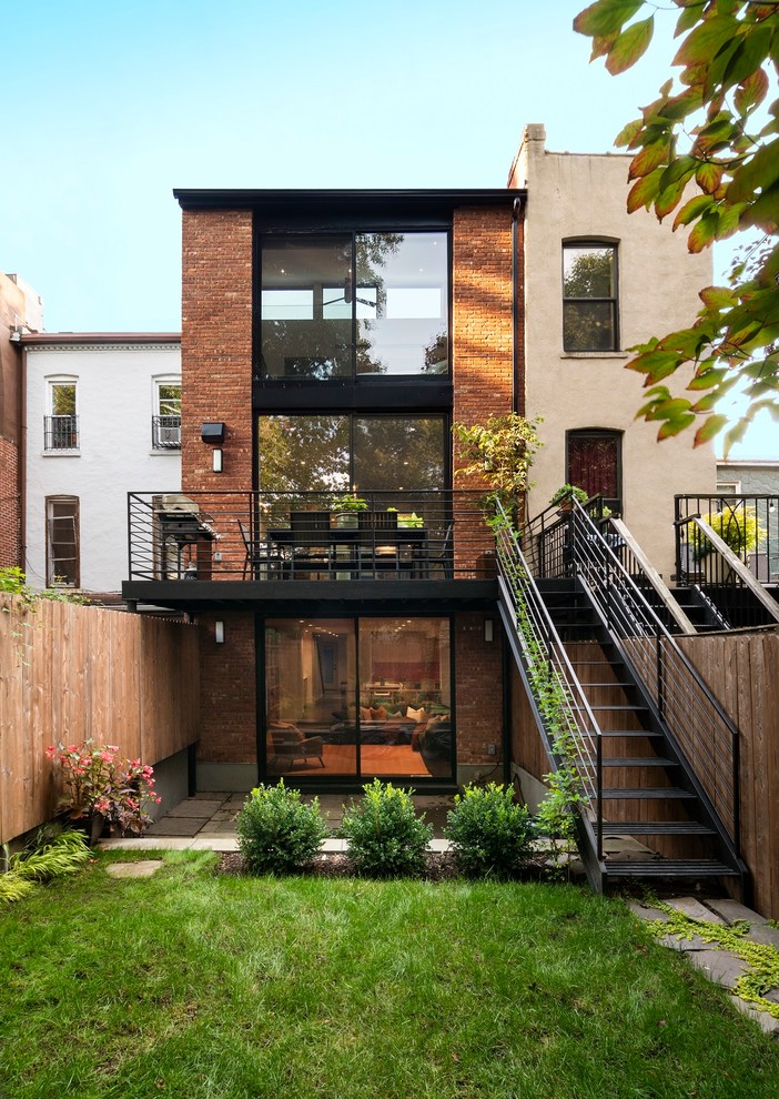 Photo of a contemporary brick terraced house in New York with three floors.
