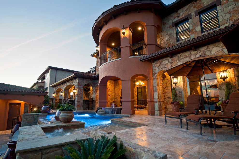 Inspiration for a huge mediterranean beige two-story stone exterior home remodel in Austin