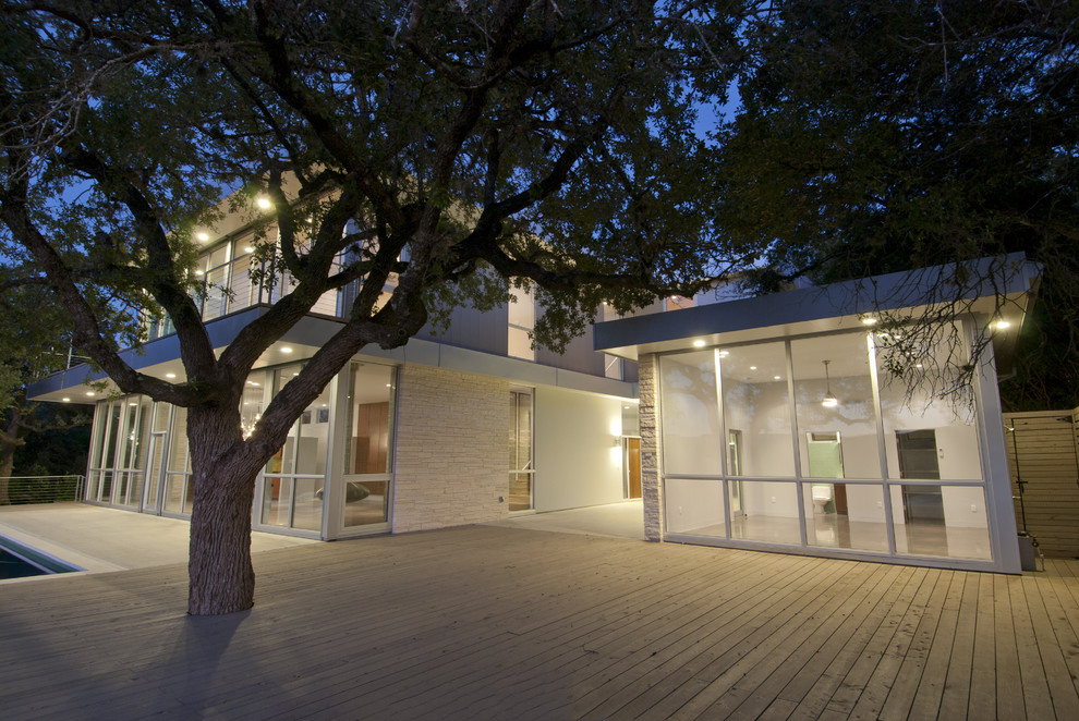 Inspiration for a modern two-story glass exterior home remodel in Austin