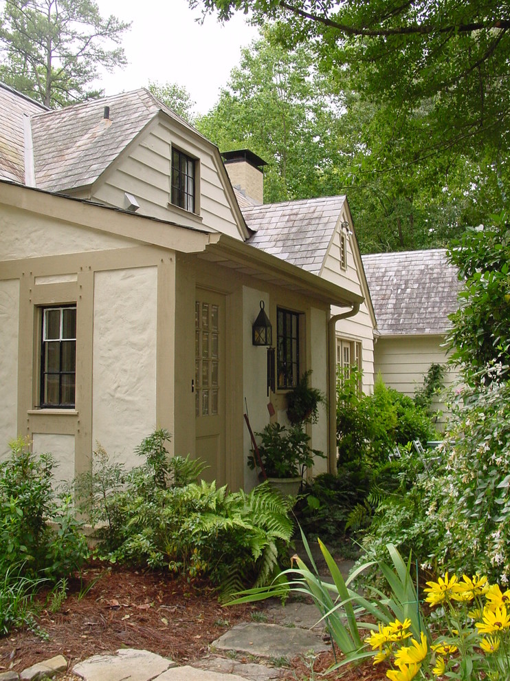 Example of a large classic beige one-story mixed siding gable roof design in Atlanta