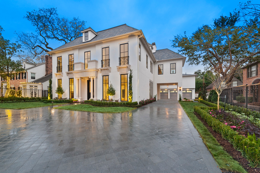 This is an example of a white classic two floor house exterior in Houston.