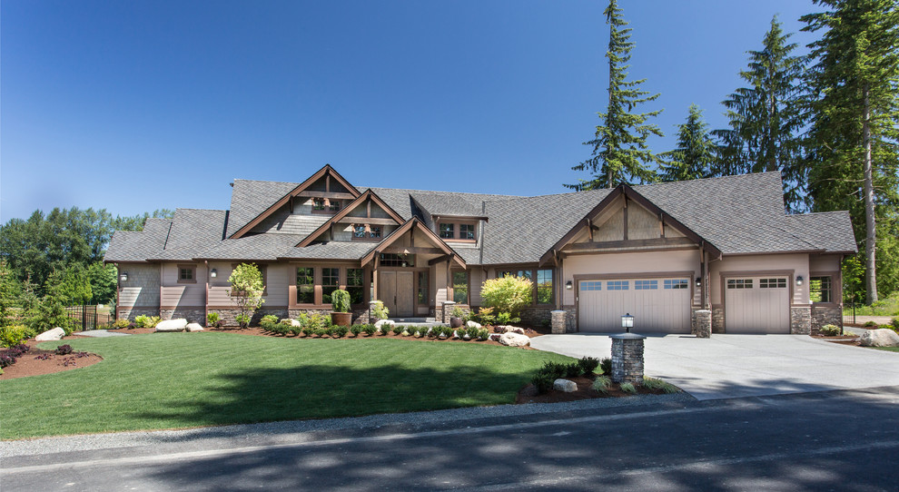 Example of a huge arts and crafts brown two-story mixed siding exterior home design in Seattle with a hip roof
