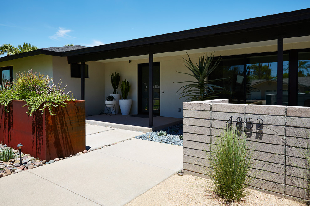 This is an example of a white modern bungalow render house exterior in Phoenix with a hip roof.