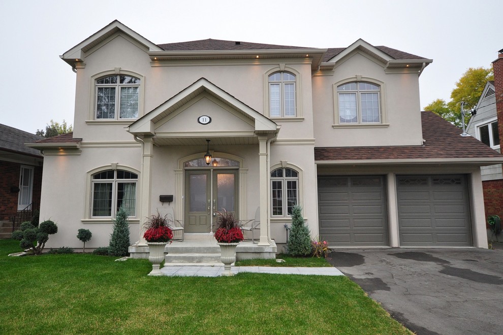 Medium sized and beige classic two floor render detached house in Toronto with a hip roof and a shingle roof.
