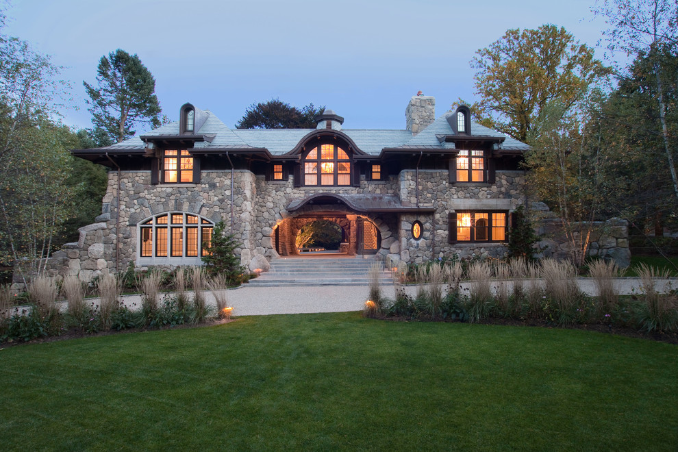 Huge mountain style three-story stone exterior home photo in Boston