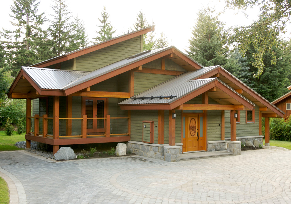 Foto de fachada de casa verde rústica grande de dos plantas con revestimiento de madera, tejado a dos aguas y tejado de metal