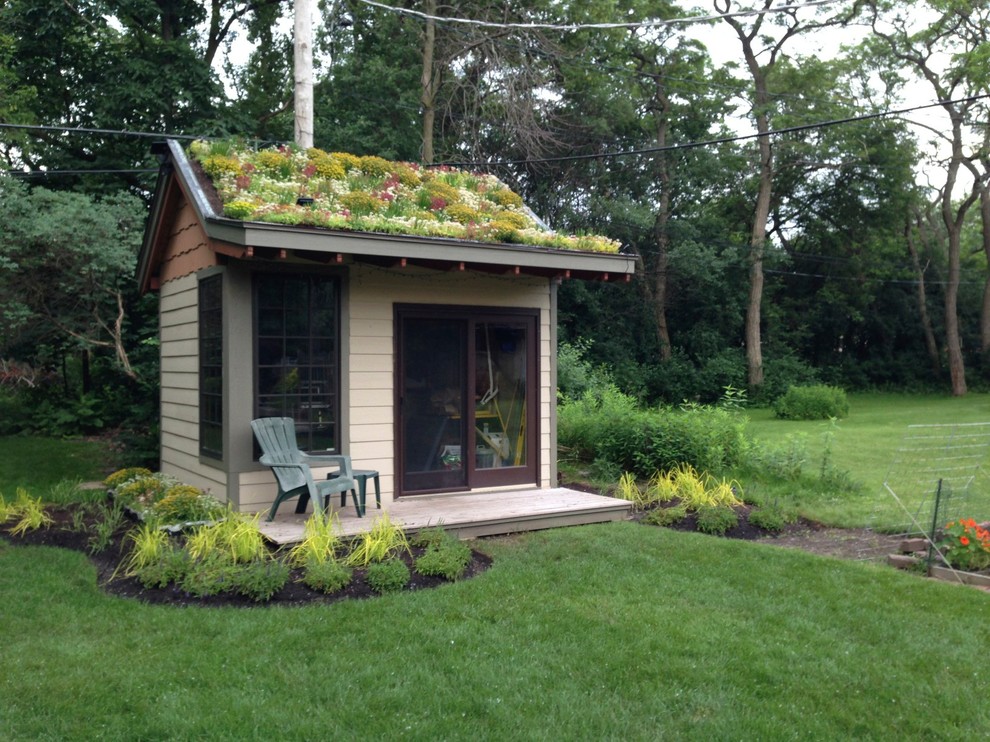 Example of a small arts and crafts beige one-story wood gable roof design in Chicago with a green roof