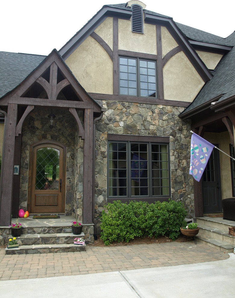 Example of a large arts and crafts brown two-story stone exterior home design in Charlotte