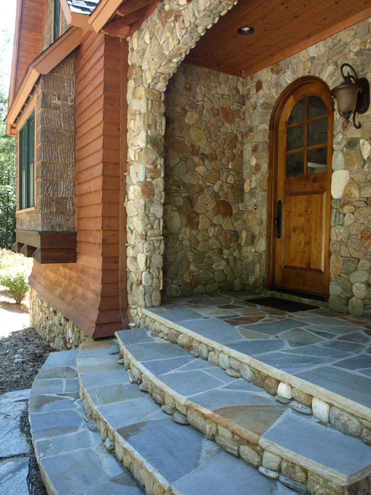 Inspiration for a large eclectic brown two-story stone exterior home remodel in Charlotte
