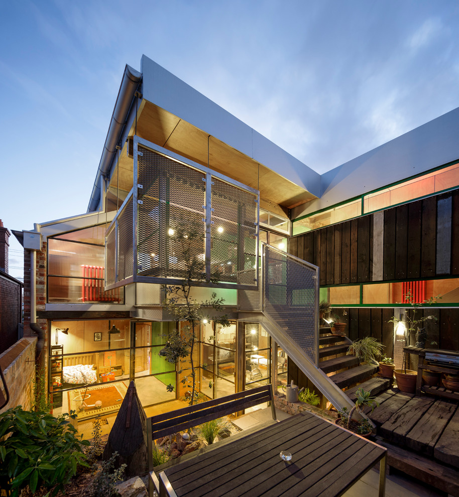Inspiration for an urban house exterior in Melbourne with metal cladding and a flat roof.
