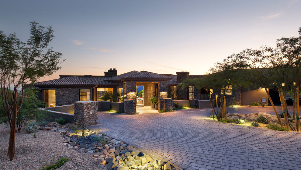 Inspiration for a huge mediterranean one-story stone exterior home remodel in Phoenix
