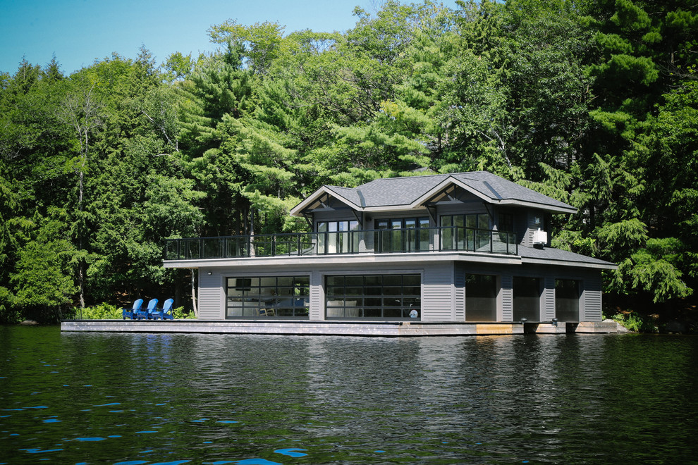 Aménagement d'une façade de maison grise bord de mer à un étage avec un toit en shingle.