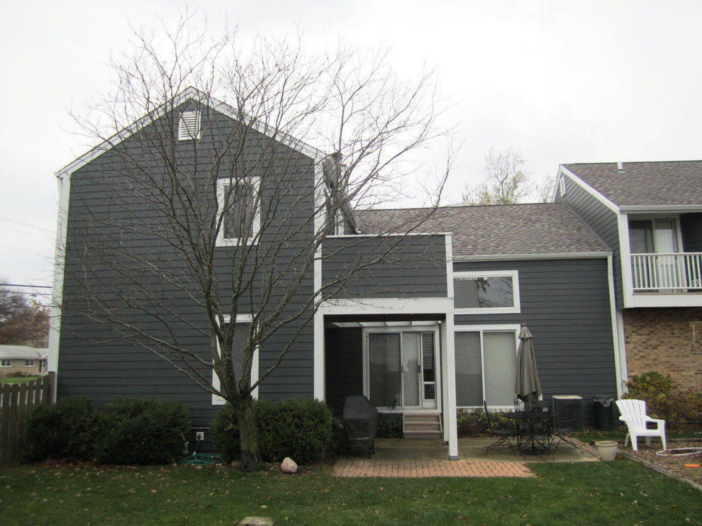 Foto de fachada de casa gris campestre de tamaño medio de dos plantas con revestimiento de aglomerado de cemento, tejado a dos aguas y tejado de teja de madera