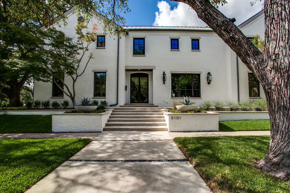 This is an example of a white classic brick house exterior in Dallas.