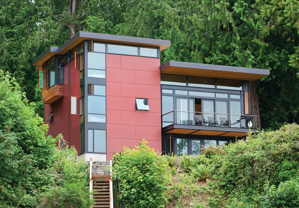 Inspiration för ett funkis rött hus, med platt tak