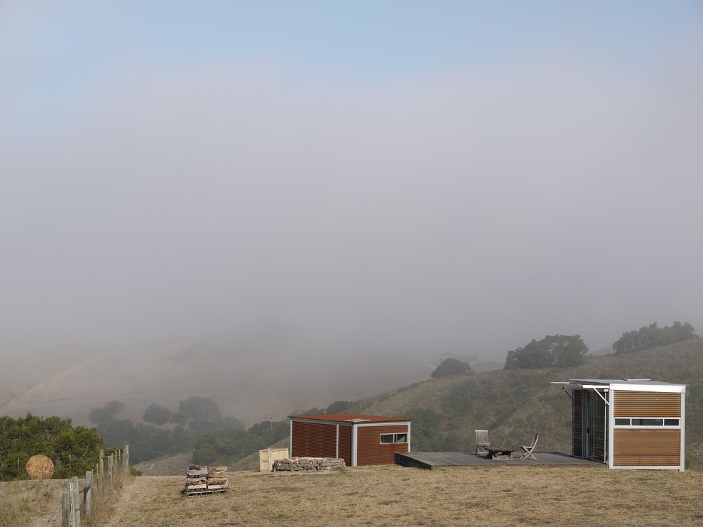 Example of a small minimalist brown one-story wood flat roof design in San Luis Obispo