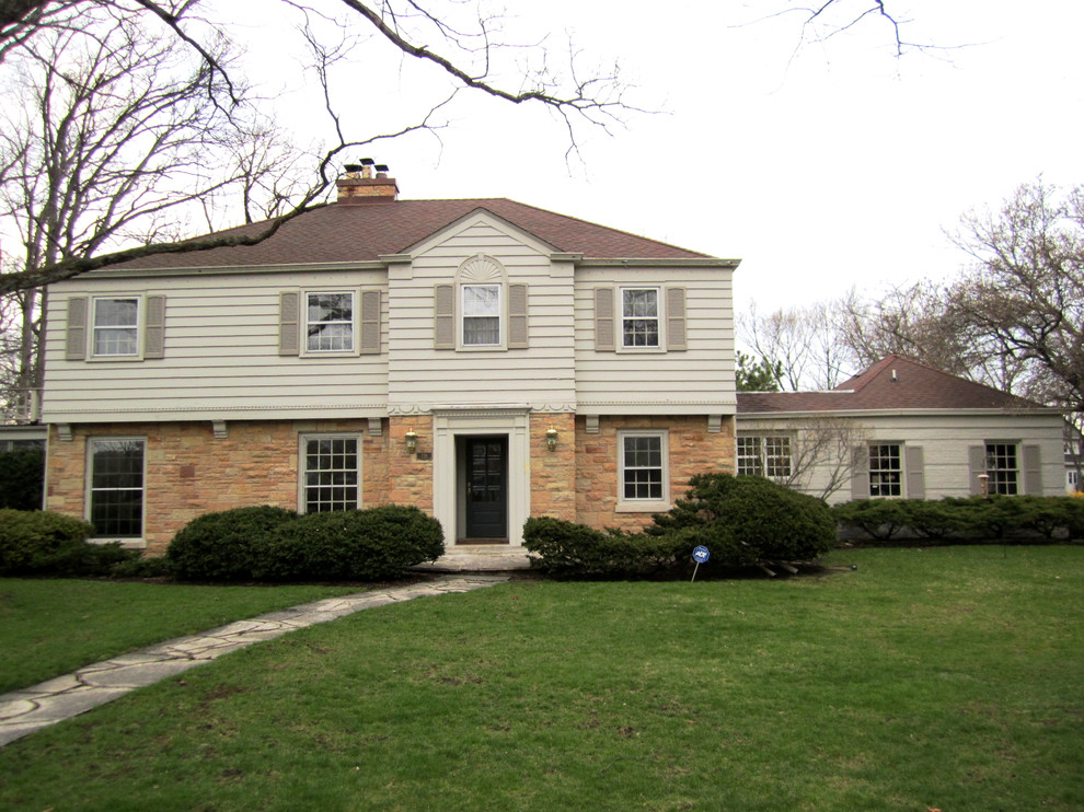 Photo of a beige and medium sized traditional two floor house exterior in Chicago with concrete fibreboard cladding.