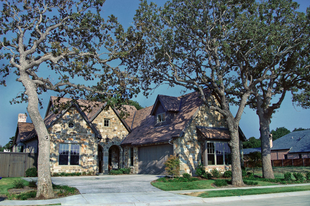 This is an example of a medium sized classic bungalow house exterior in Dallas with stone cladding.