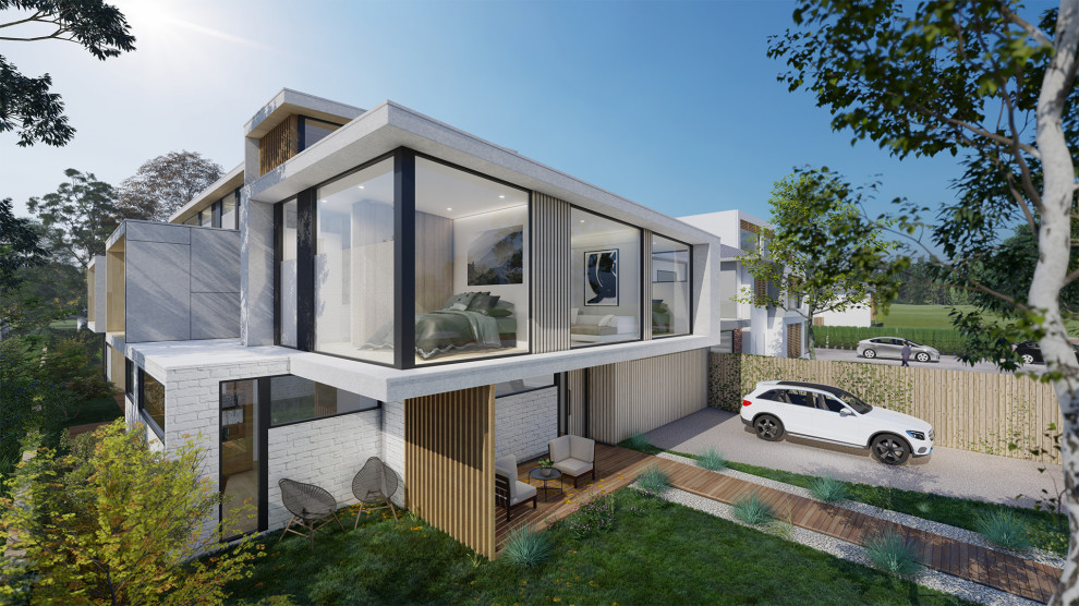 Стильный дизайн: трехэтажный, серый многоквартирный дом среднего размера в современном стиле с облицовкой из бетона и металлической крышей - последний тренд