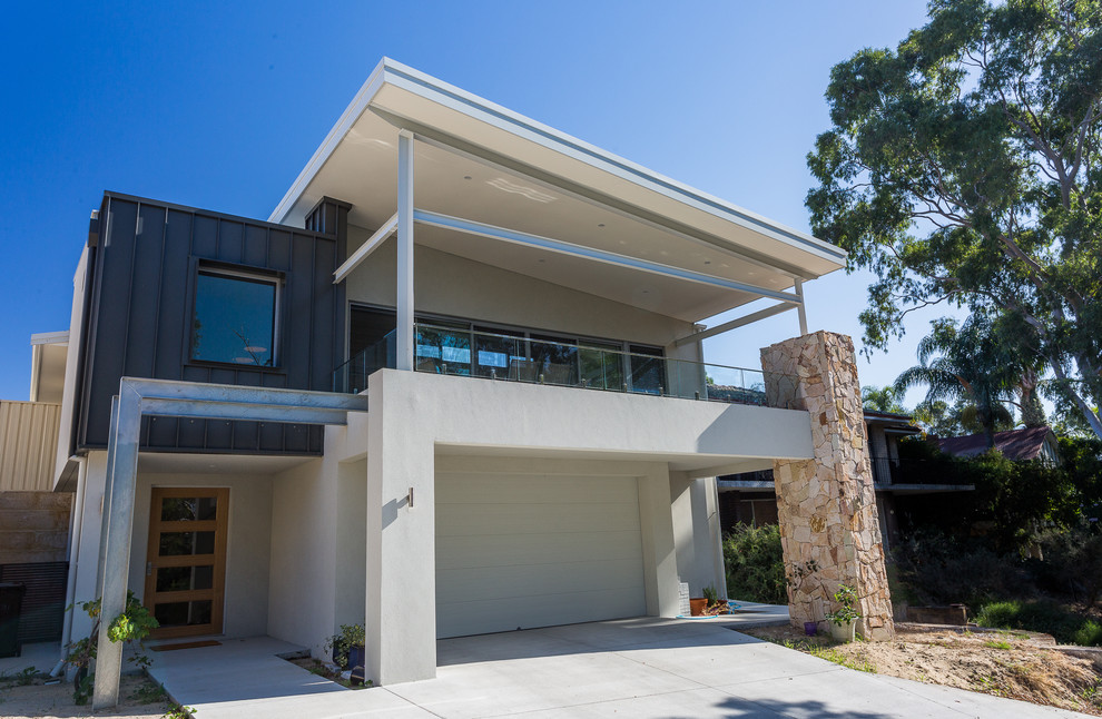 Large urban white two-story stone exterior home photo in Perth with a metal roof
