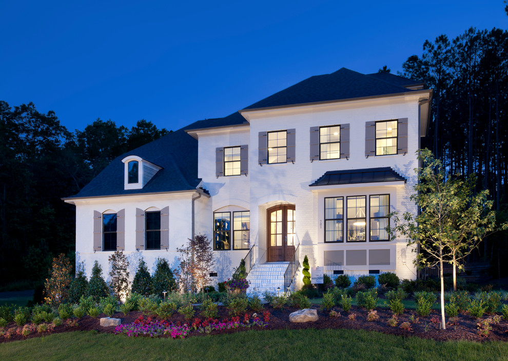 Inspiration for a transitional white two-story house exterior remodel in Atlanta with a hip roof and a shingle roof