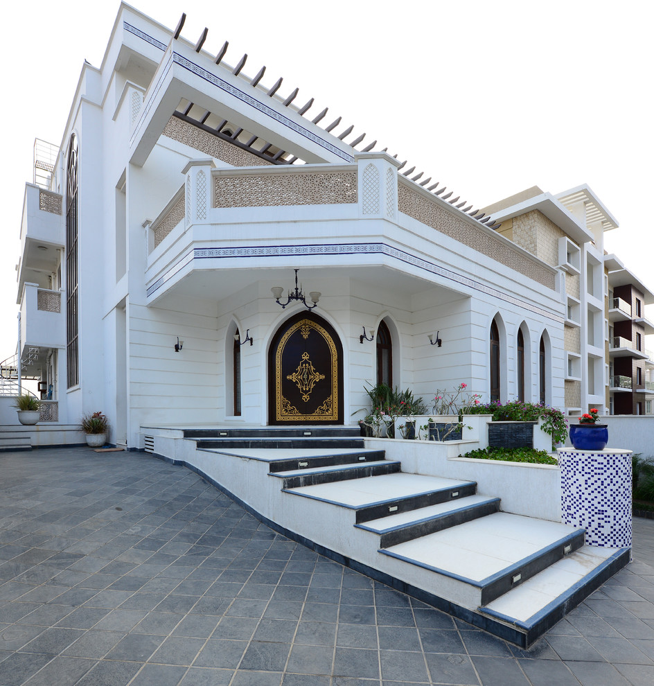 Example of a huge asian white three-story exterior home design in Hyderabad
