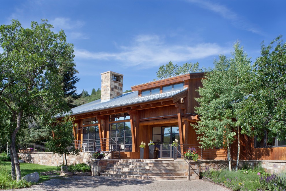 This is an example of a rustic house exterior in Denver with wood cladding.