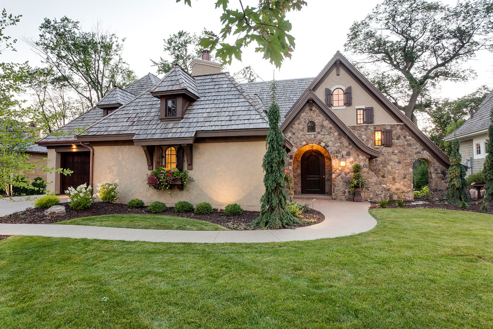 Beige traditional house exterior in Minneapolis with three floors and stone cladding.