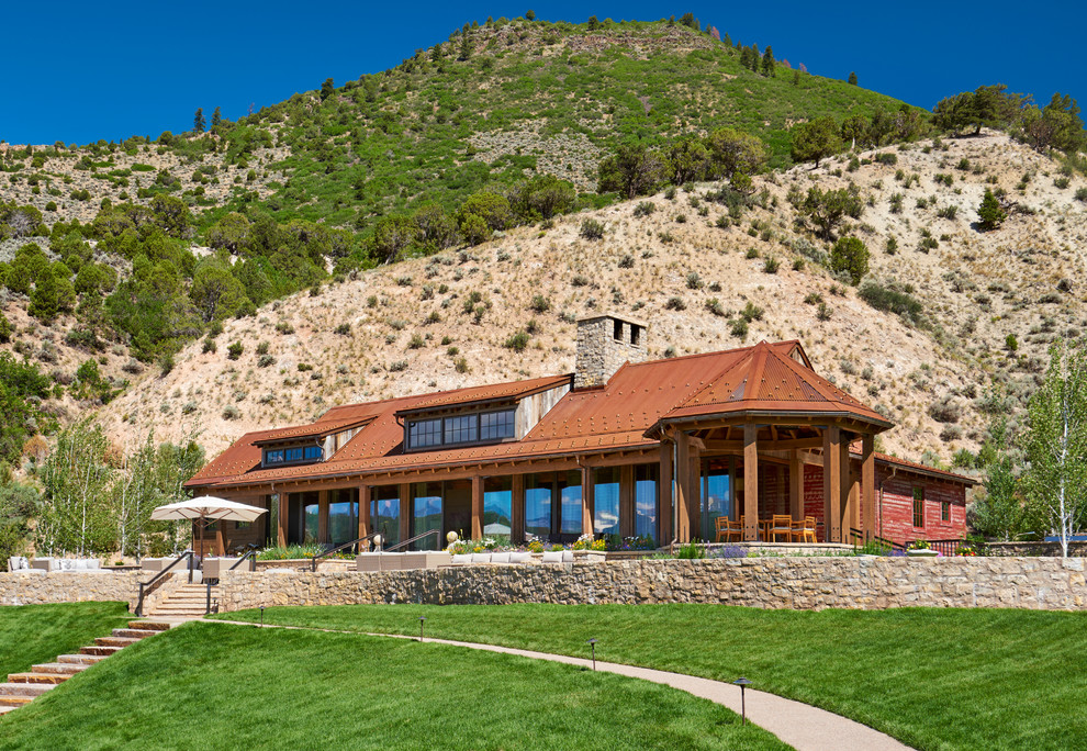 Large and red rustic detached house in Denver with wood cladding, a metal roof and a pitched roof.