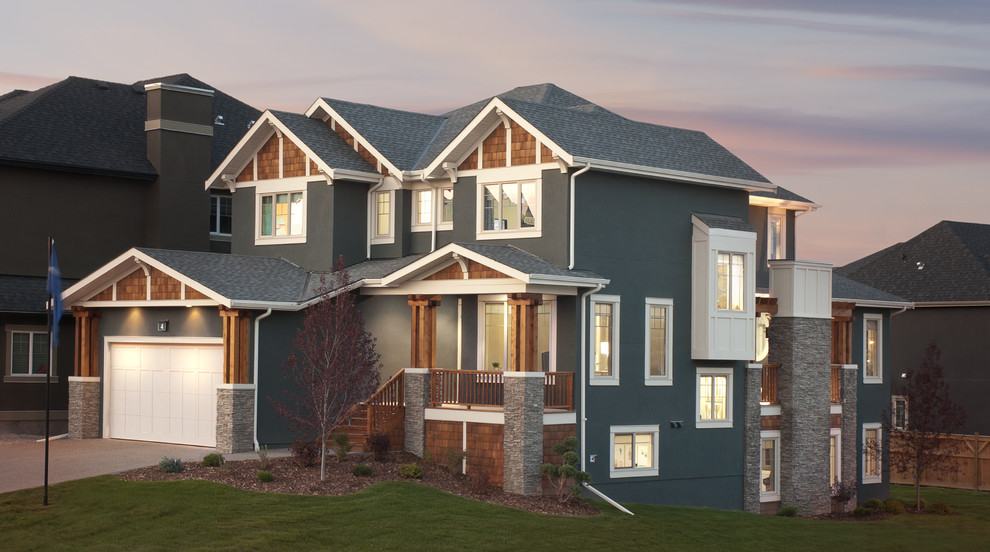 Example of a large arts and crafts gray three-story mixed siding gable roof design in Calgary