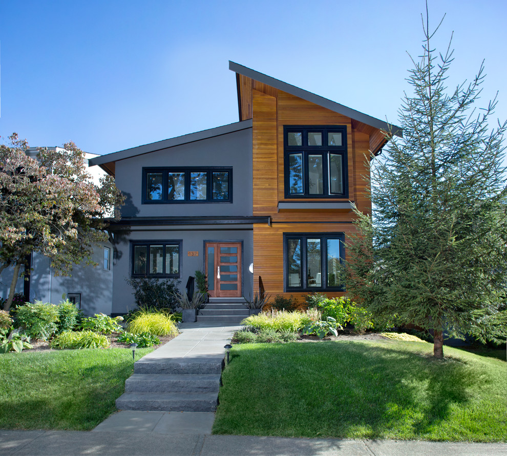 Example of a trendy two-story exterior home design in Vancouver with a shed roof