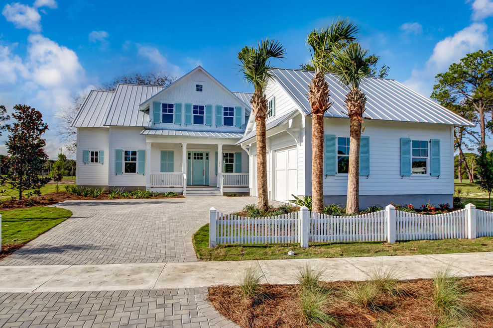 Mid-sized coastal white two-story wood house exterior idea in Jacksonville with a hip roof and a metal roof
