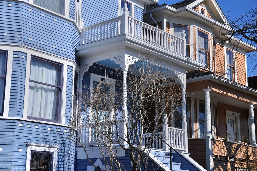 Medium sized and blue victorian two floor house exterior in Vancouver with wood cladding and a pitched roof.