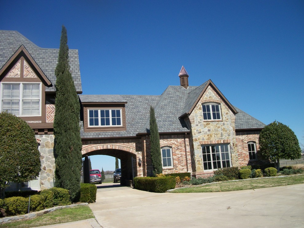 Example of a large transitional multicolored one-story brick exterior home design in Dallas with a shingle roof