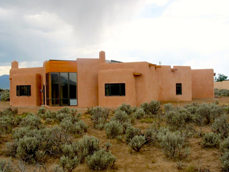 Example of a large southwest beige one-story concrete exterior home design in Albuquerque