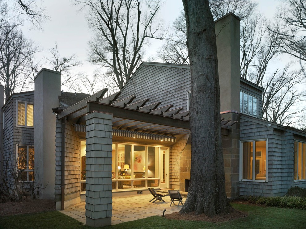 Diseño de fachada de casa gris retro grande de dos plantas con revestimiento de madera, tejado a cuatro aguas y tejado de teja de madera