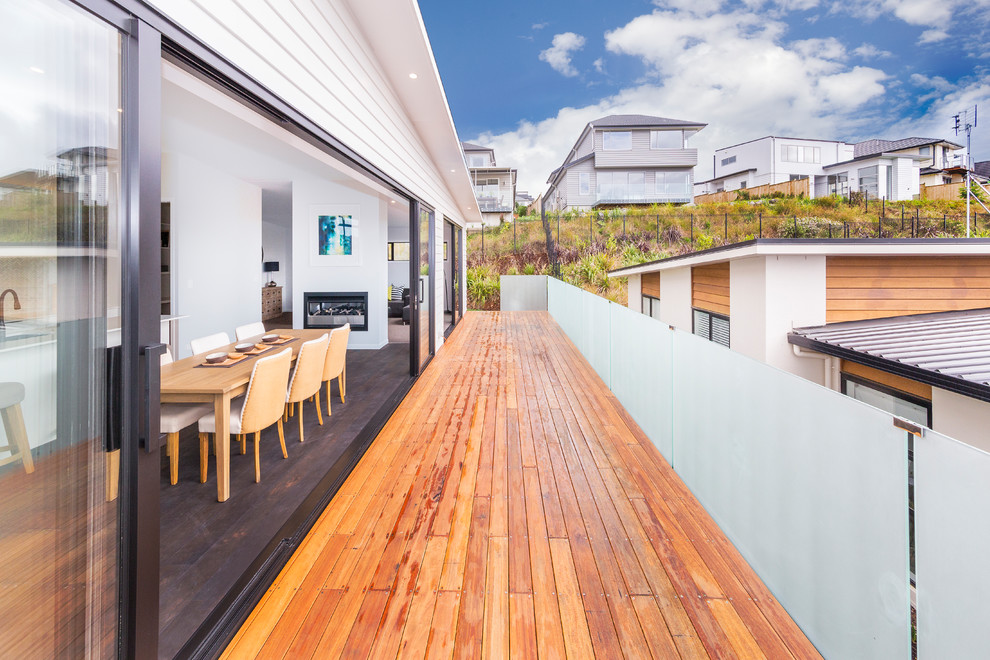 Large minimalist brown two-story vinyl exterior home photo in Auckland