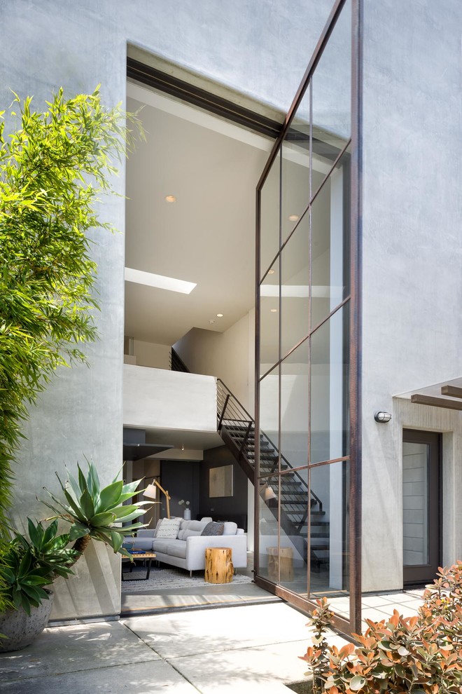 Design ideas for a gey contemporary concrete house exterior in Santa Barbara with three floors.