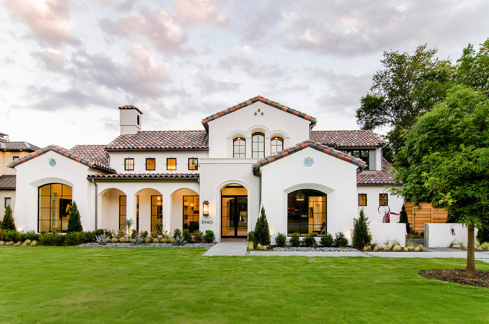 Zweistöckiges Mediterranes Haus mit weißer Fassadenfarbe und Satteldach in Dallas