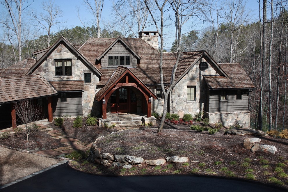 Example of a large mountain style gray two-story mixed siding gable roof design in Other