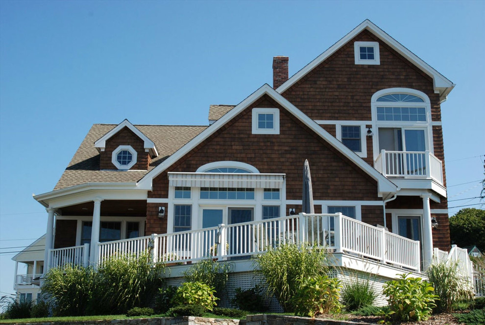 Inspiration for a large coastal brown three-story wood exterior home remodel in Cedar Rapids with a shingle roof
